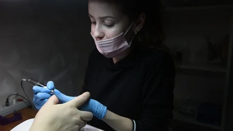 Master uses an electric machine to remove the nail polish during manicure Video stock 120907811