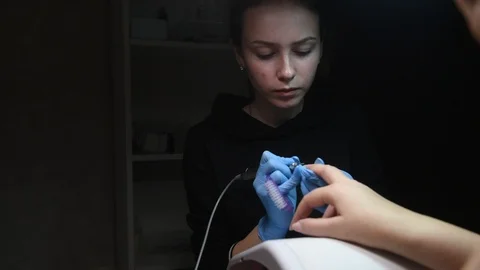 Master uses an electric machine to remove the nail polish during manicure Stock Footage 120907962