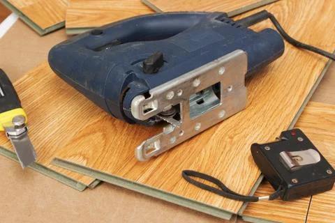 Master using an electric jigsaw saws laminated panel Stock Photos