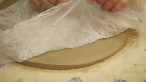 Master using a plastic bag to align the sharp edges of the clay plate. 動画素材 148855230