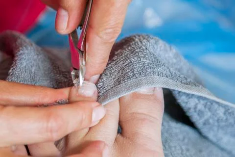 Master using professional instruments when doing pedicure. Pedicure treatment Stock Photos
