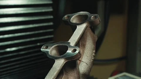 Master in a white glove checks the quality of the part after grinding a car Stock Footage 284545431