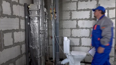 Master, worker checks the water meter in the apartment Stock Footage 115418036