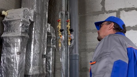 Master, worker checks the water meter in the apartment Stock Footage 115418065