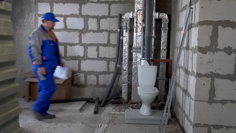 Master, worker checks the water meter in the apartment Stock Footage 115418123