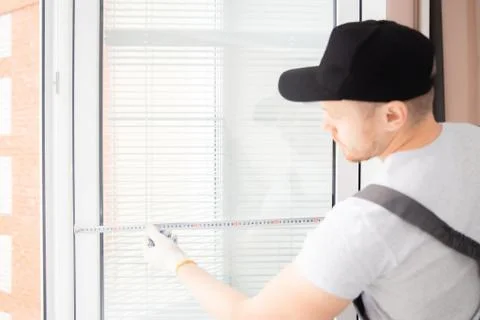 Master worker measures upvc window with ruler, installation process Stock Photos