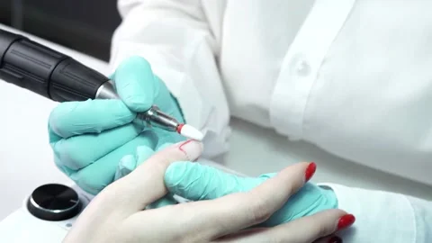 Master is working with the client's nails using a manicure machine Stock Footage 194463757