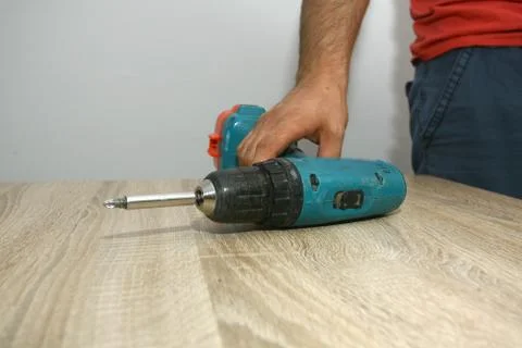 The master working with drill over new kitchen cases Stock Photos