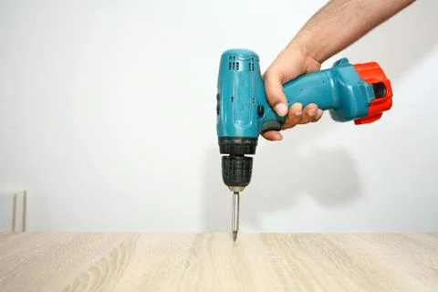 The master working with drill over new kitchen cases Stock Photos
