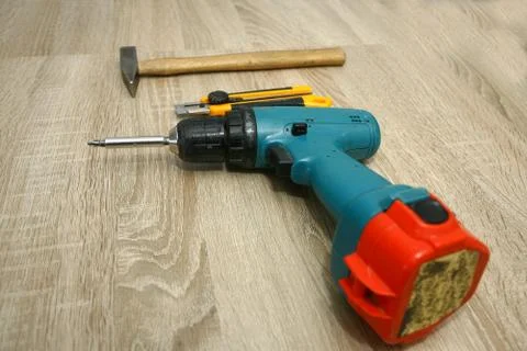 The master working with drill over new kitchen cases Stock Photos