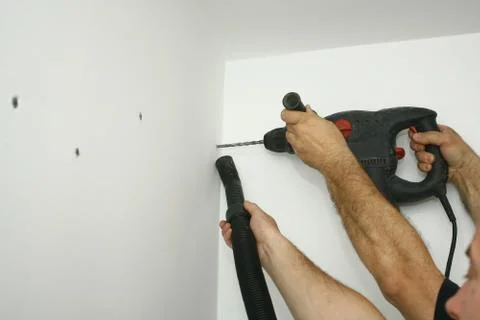 The master working with drill over new kitchen cases Stock Photos