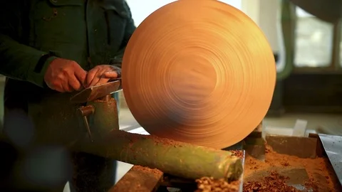 The master working on woodworking lathe machine. Carpenter scrape on the lathe a Stock Footage 124692076