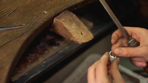 Master in the workplace makes the accessory with instruments Stock Footage 73462943