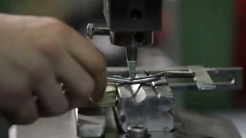 The master works behind the machine with metal. close work behind the machine Stock Footage 126397538