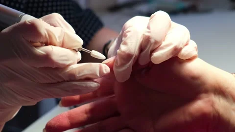 The master works with the client's nails using a manicure machine. Video stock 153450503