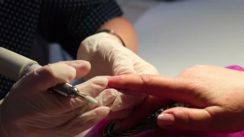 The master works with the client's nails using a manicure machine. Stock Footage 153660047
