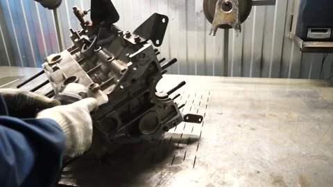 The master works with the disassembled engine on the table Stock Footage 145660839