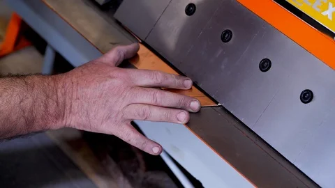 The master works with a machine for bending copper sheets 스톡 동영상 124471631