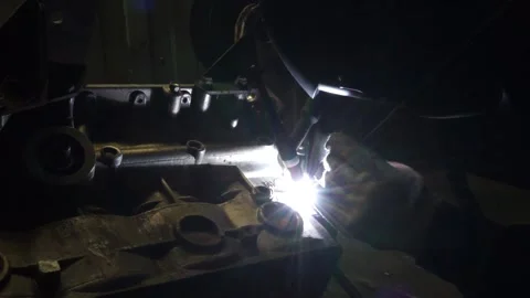 Master works welding with the engine disassembled on the table Stock Footage 145660881