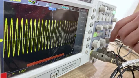 The master in the workshop sets up the oscilloscope for operation. Set up mus Stock-Footage 130779464