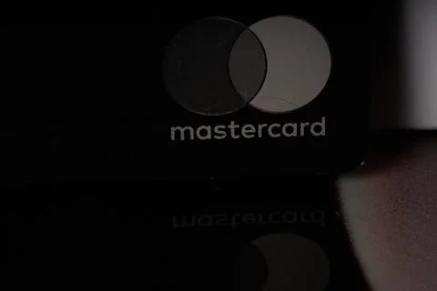 Mastercard logo with reflection in the glass table Stock Photos