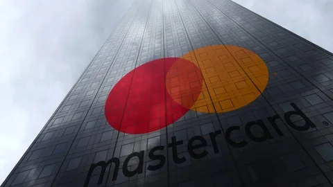 MasterCard logo on a skyscraper facade reflecting clouds, time lapse. Editorial Stock Footage 81110882