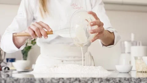 Masterful Chef Adding Yeast to Flour Well for Artisan Bread 動画素材 246947633