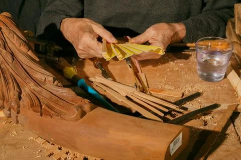 Masterful craftsmanship in woodworking involves skilled hands crafting comple Stock Photos