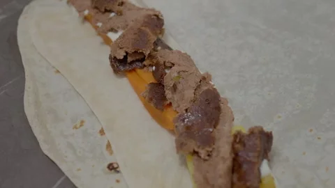 Masterful hands create a flavorful kebab with fresh toppings on lavash bread Stock Footage 329268906