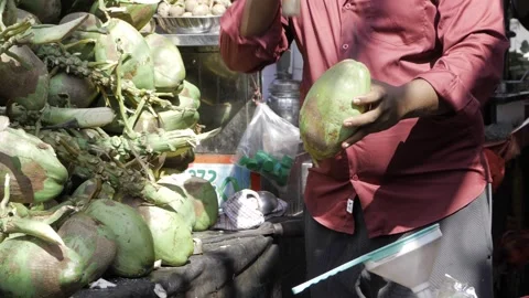 Masterful Knife Work on Coconuts in Market Bliss Stock Footage 327533740