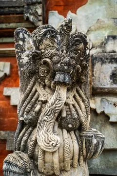 Masterfully carved temple protector statue displays detailed facial feature.. Stock Photos