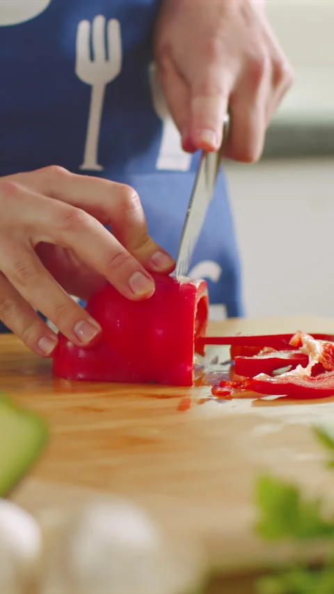 Mastering the art of cutting bell peppers in a cozy kitchen setting Stock Footage 341762617