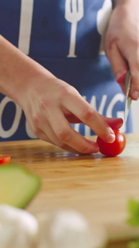 Mastering the art of cutting tomatoes in a bright kitchen setting Stock Footage 341762670