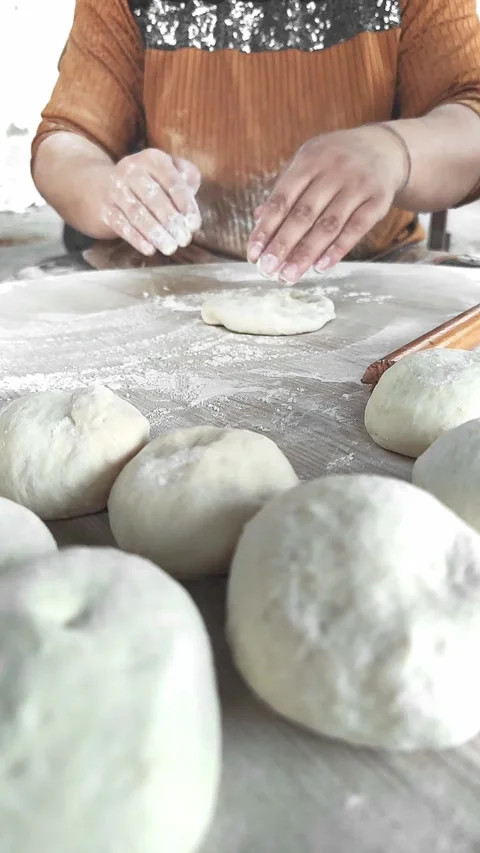 Mastering the Art of Dough in a Cozy Kitchen Setting While Preparing Bread Video stock 314116755