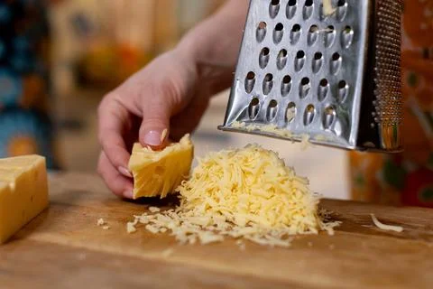 Mastering the essential skill of grating cheese is crucial for all chefs in the Stock-Fotos