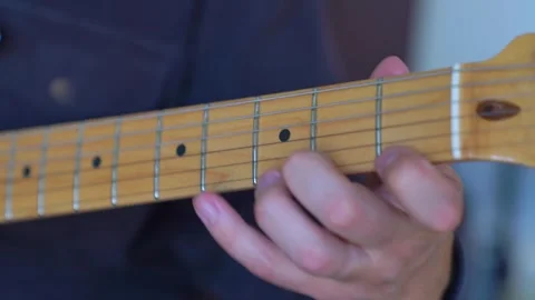 Mastering guitar chords through hands-on practice in a cozy setting Stock Footage 311126350