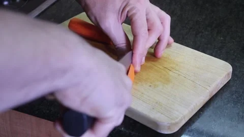 Mastering knife skills while chopping vegetables in a kitchen setting Stock Footage 294622968