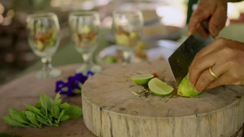 Mastering lime cutting for refreshing drinks in an outdoor culinary class Stock Footage 301541268