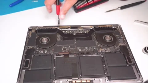 Mastering notebook computer repair techniques in a focused workshop setting Stock Footage 309804132