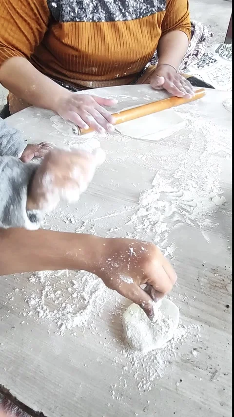 Mastering Pita Bread Together: a Bonding Moment in the Kitchen Stock Footage 311176162