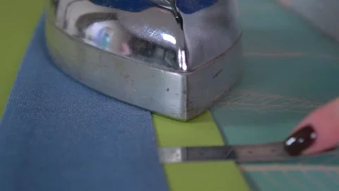 Mastering Precision Ironing Techniques while working with a variety of Tailoring Stock Footage 310249068