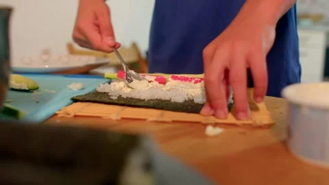 Mastering sushi creation through repetitive rolling and filling methods Stock Footage 321027854