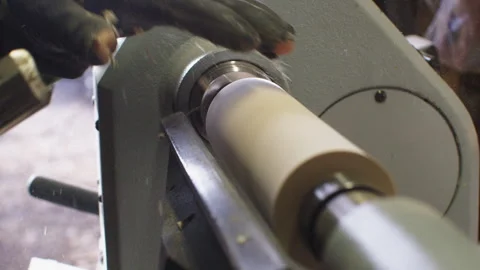 Mastering woodturning techniques on a spinning carving machine in workshop Stock Footage 321384740