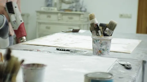 Masters in the art studio process the tree with a construction hair dryer Stock Footage 96276522