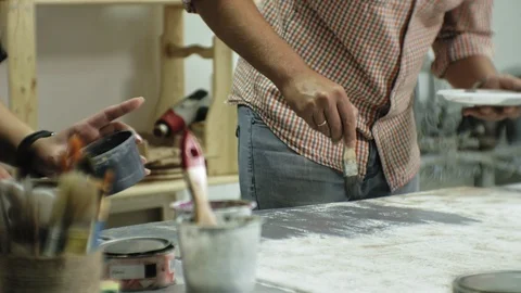 Masters in the art studio process the wood with paint and putty, achieve the Stock Footage 96277023