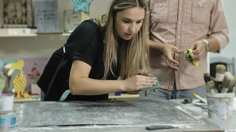 Masters in the art studio process the wood with paint and putty, achieve the Stock Footage 96278112