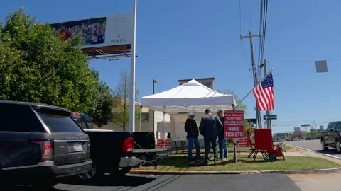 Masters golf ticket scalper side view tent and people with parked cars clear  Stock Footage 174735964