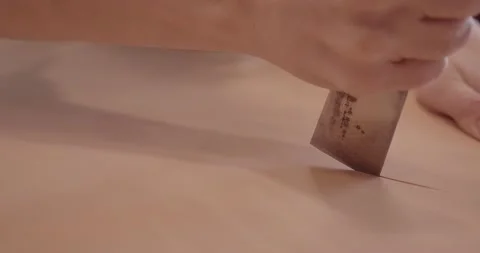 Master's hand with a knife while working with leather. Stock-Footage 147495937