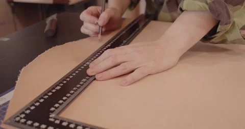 Master's hand with a ruler while working with leather. Stock-Footage 147629385