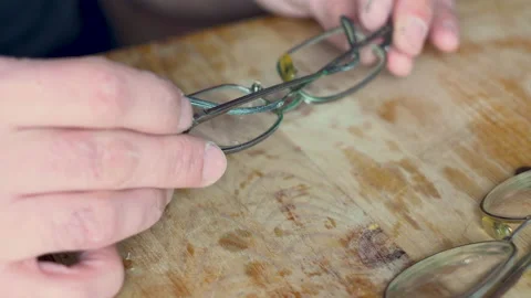 Master's hands hold old glasses 4K Stock Footage 150286754